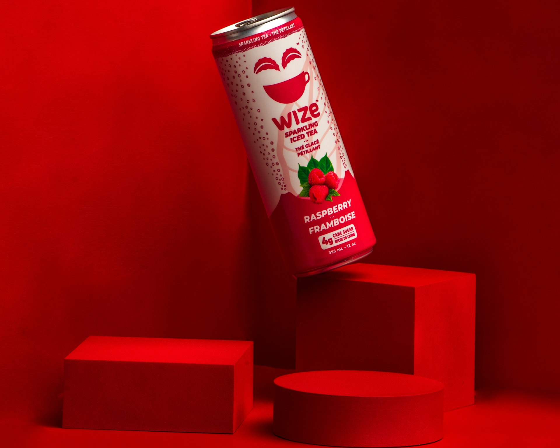 a can of soda sitting on top of a red block